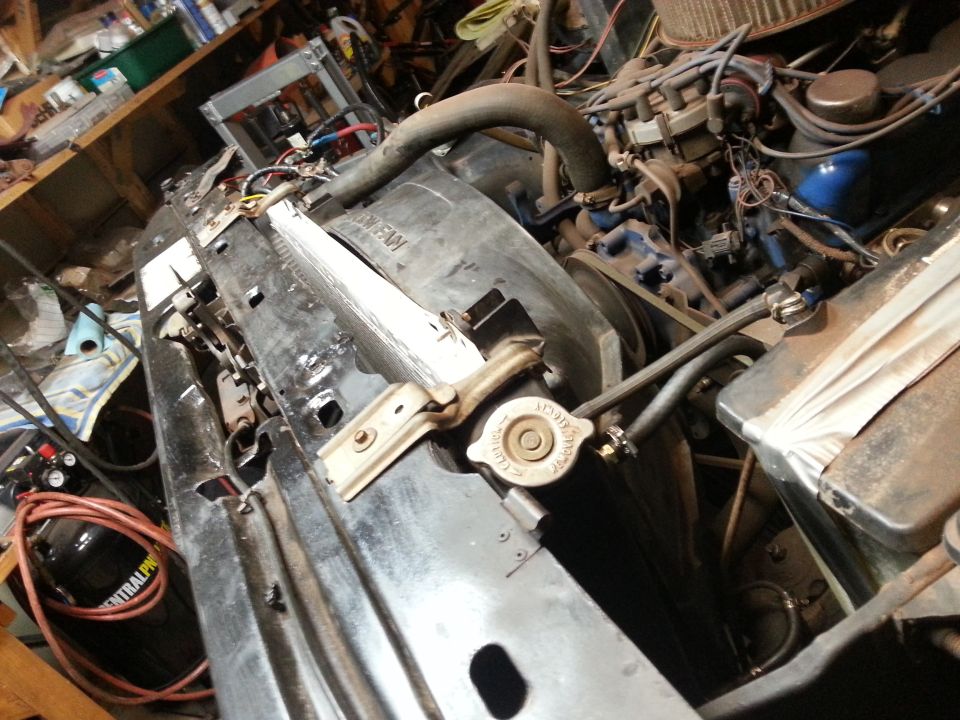 Engine bay with radiator support and engine during work