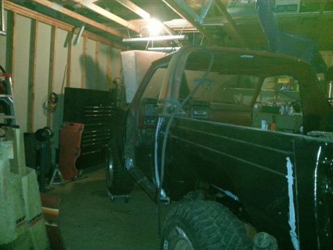 Truck body on a lift in a dimly lit garage