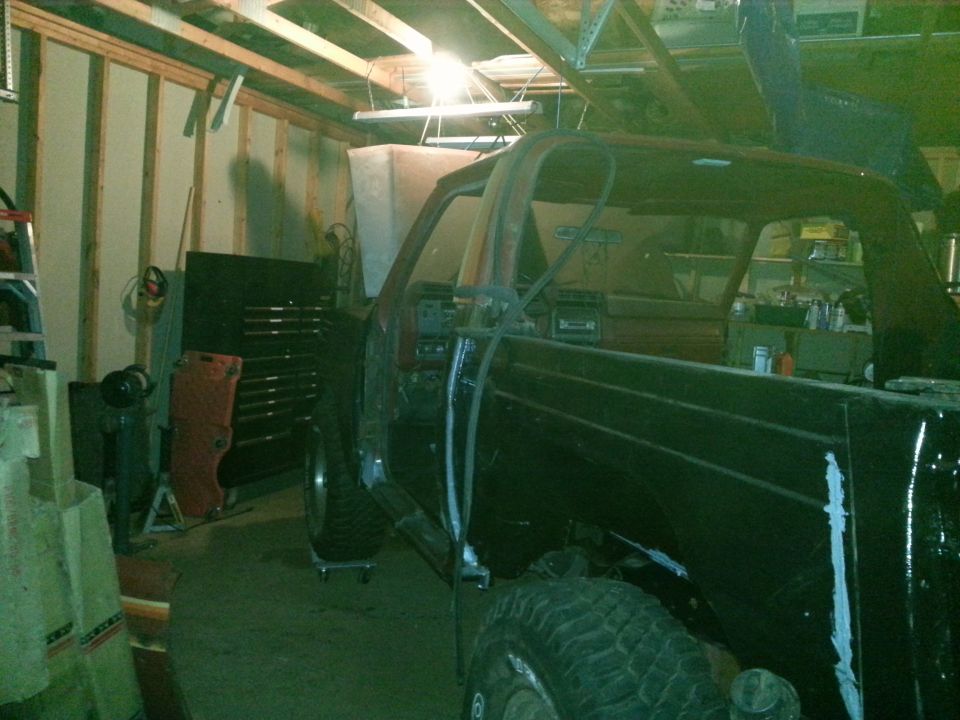 Truck body on a lift in a dimly lit garage