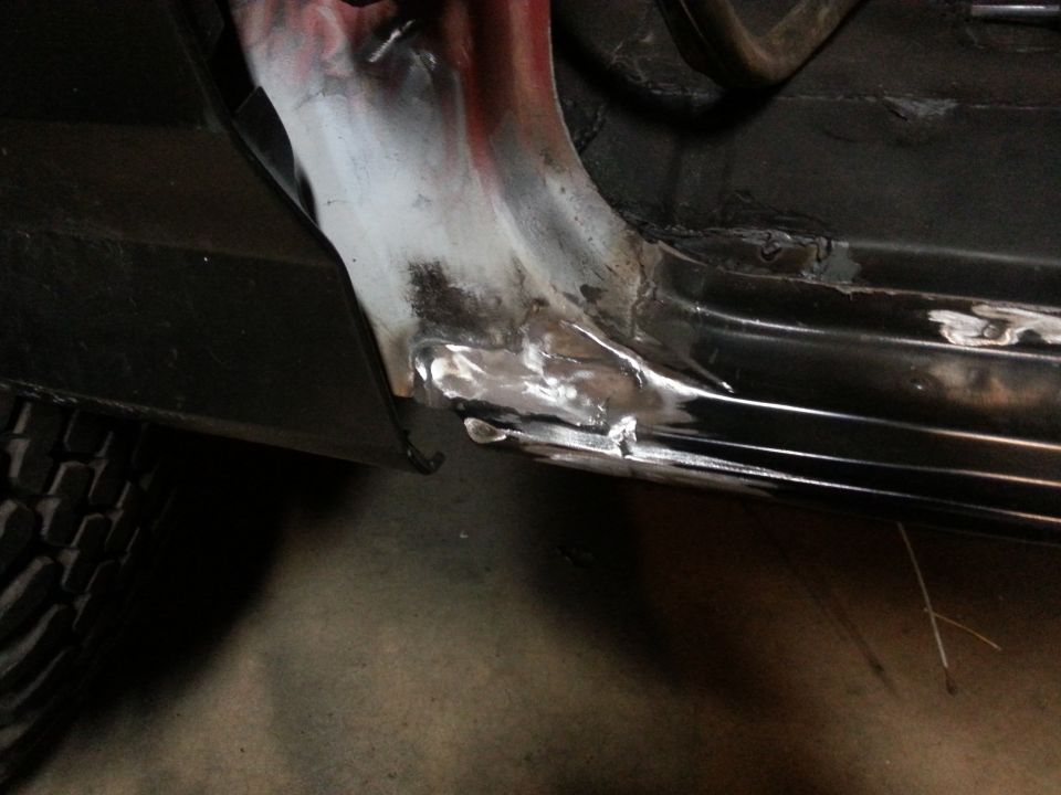 Close-up photo of welded and ground metal repair on a vehicle rocker panel