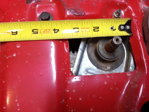 Photo of a tape measure across an opening in a red vehicle panel