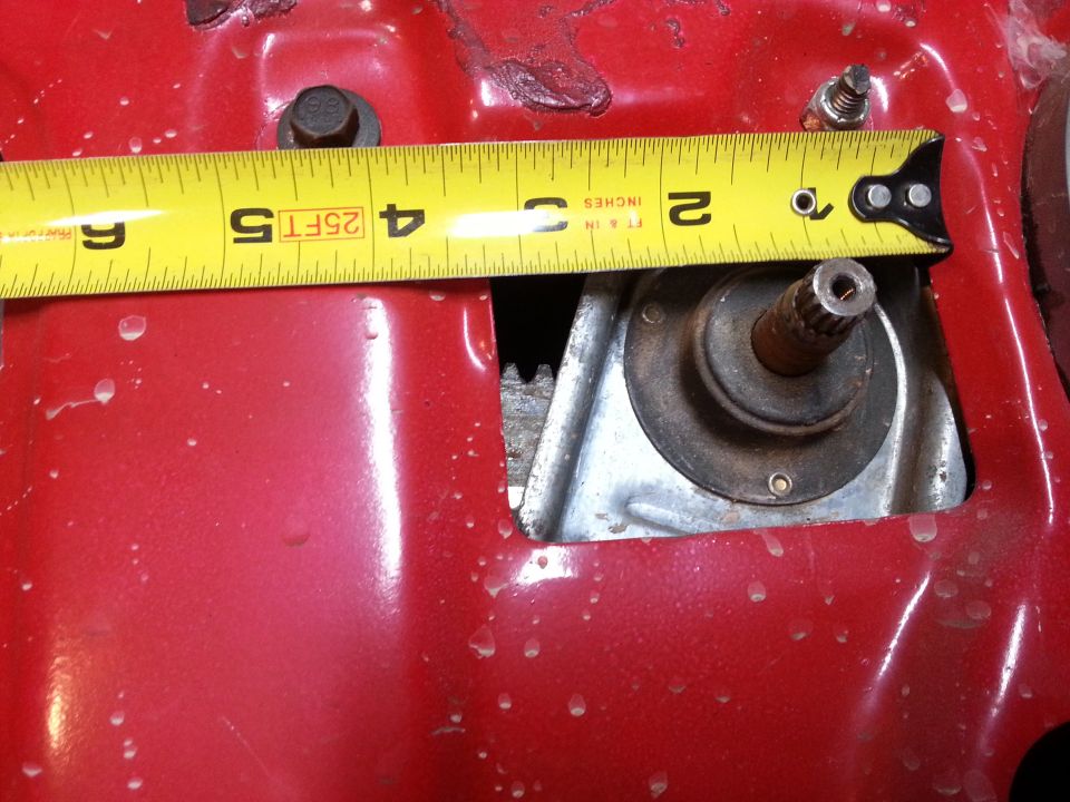 Photo of a tape measure across an opening in a red vehicle panel