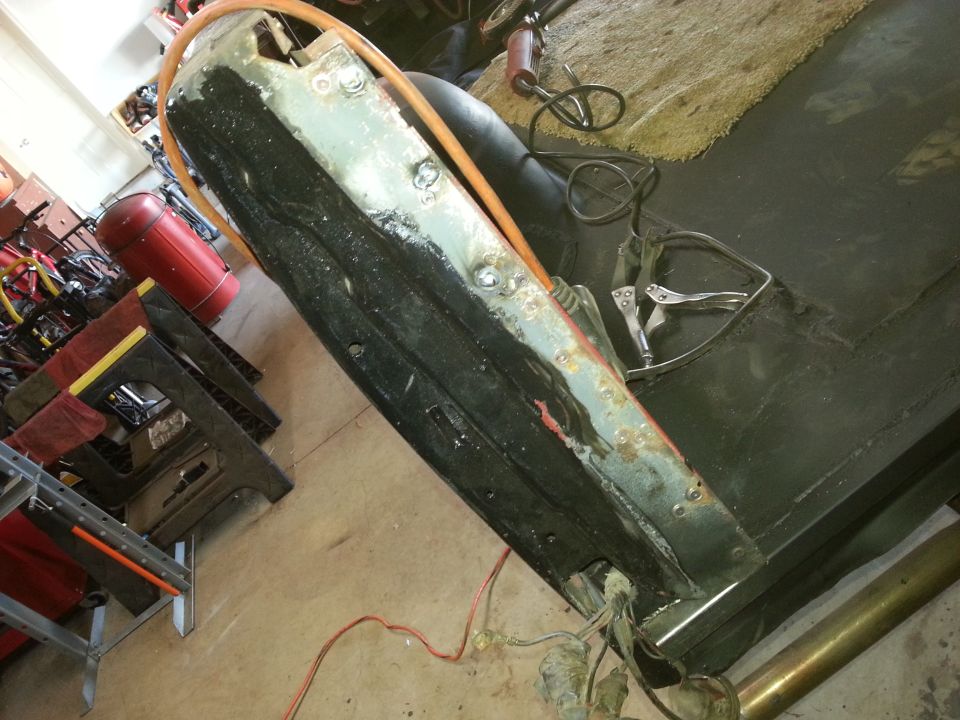 Photo of a vehicle bed or quarter panel laid down during restoration in a garage