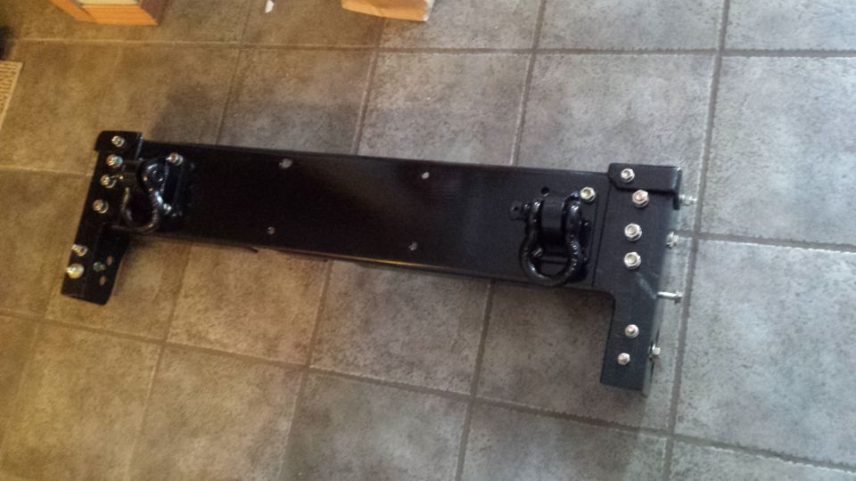 Black fabricated steel bumper or crossmember on a tile floor