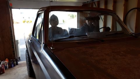 Windshield and cab of a classic vehicle parked in a garage