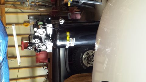 Vertical Central Pneumatic air compressor and Ford truck in a garage