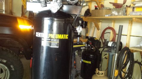 Two Central Pneumatic air compressors in a garage workshop