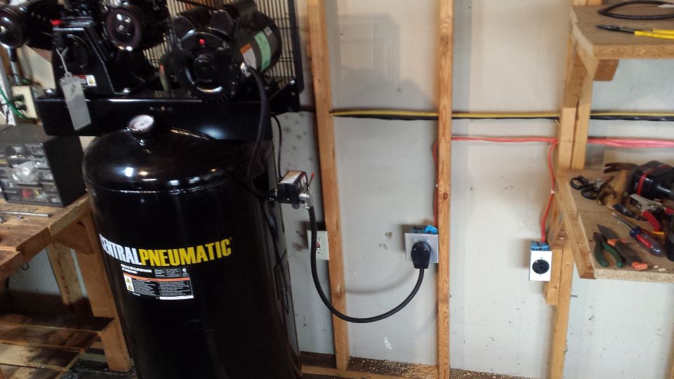 Air compressor plugged into garage outlets with electrical conduit