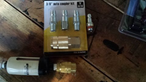 3/8 inch auto coupler kit package with fittings on a bench