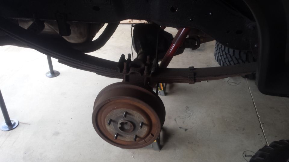 Rear axle, drum brake, and leaf spring of a truck on jack stands
