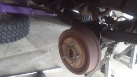Truck rear brake drum and hub with leaf spring on jack stands