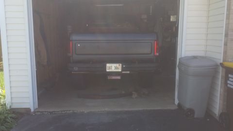 Rear of a pickup truck parked in a garage with Illinois plate