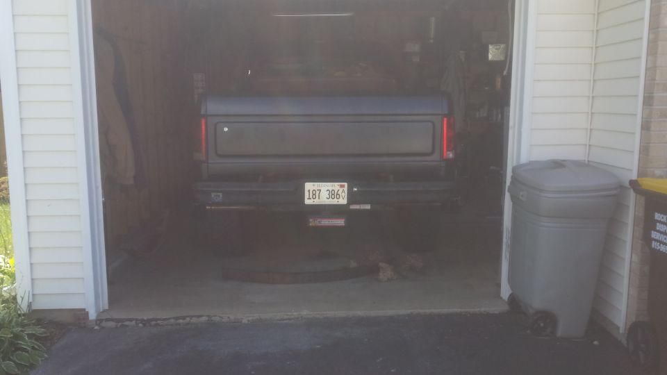Rear of a pickup truck parked in a garage with Illinois plate