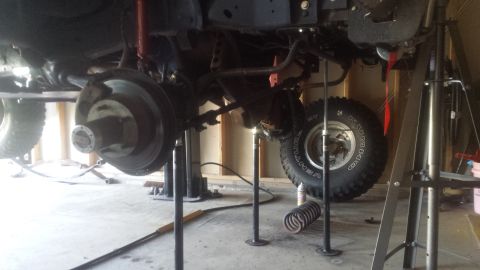 Front axle, brakes, and suspension of a truck on jack stands
