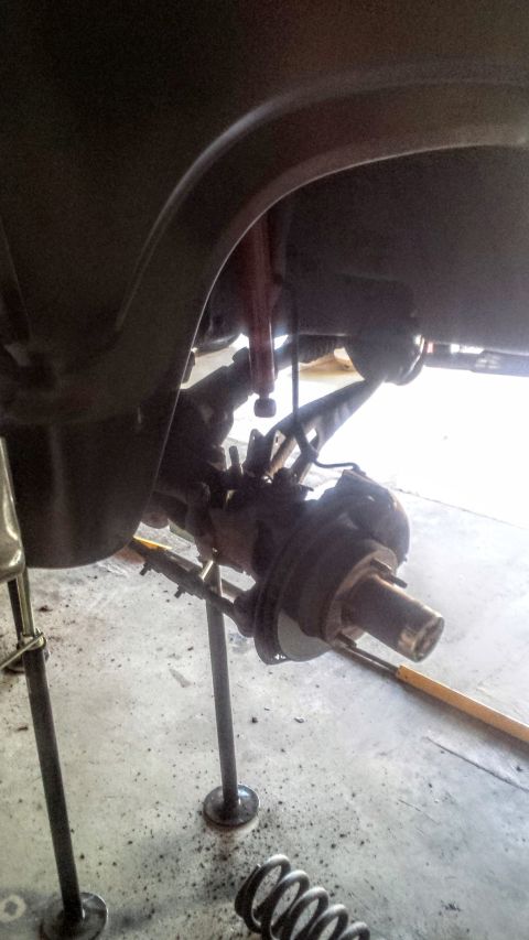 Front axle hub and radius arm of a truck on jack stands