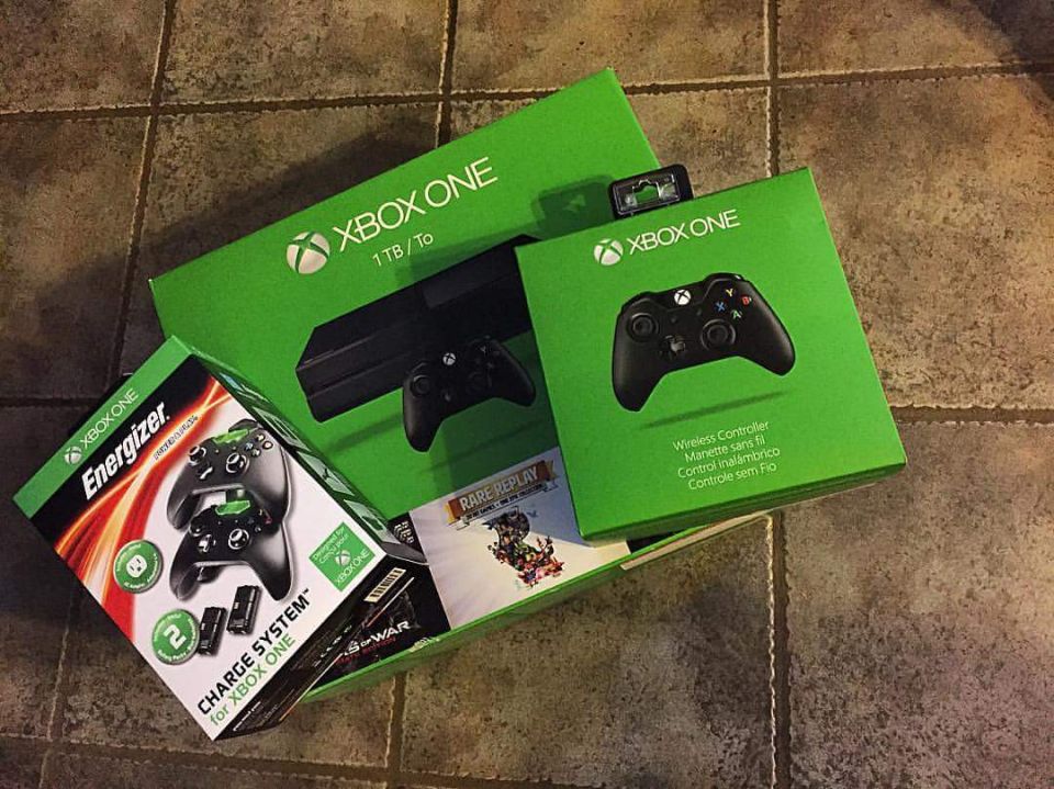Photo of Xbox One console and accessory retail boxes on a floor