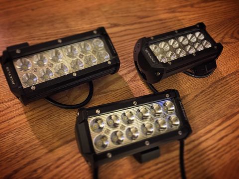 Photo of three LED light bars resting on a wood floor
