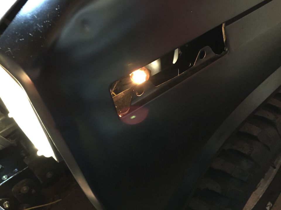 Photo of a truck fender with an amber side marker light illuminated