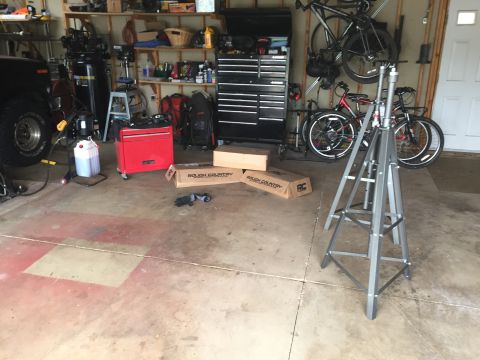 Garage interior with Rough Country boxes, tool chest, bikes and a tripod