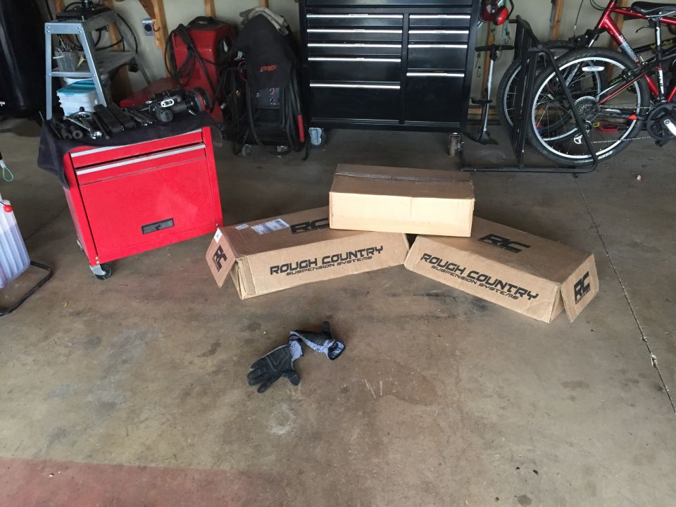 Wooden ramp and jack stands on a garage floor