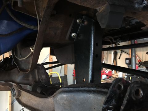 Newly installed black bracket bolted to a vehicle frame