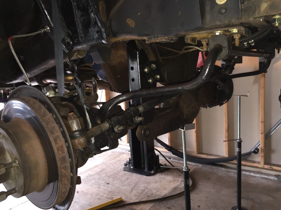 Front axle, brake disc and suspension under a lifted truck