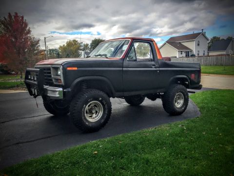 Side profile of a lifted Ford Bronco in a driveway