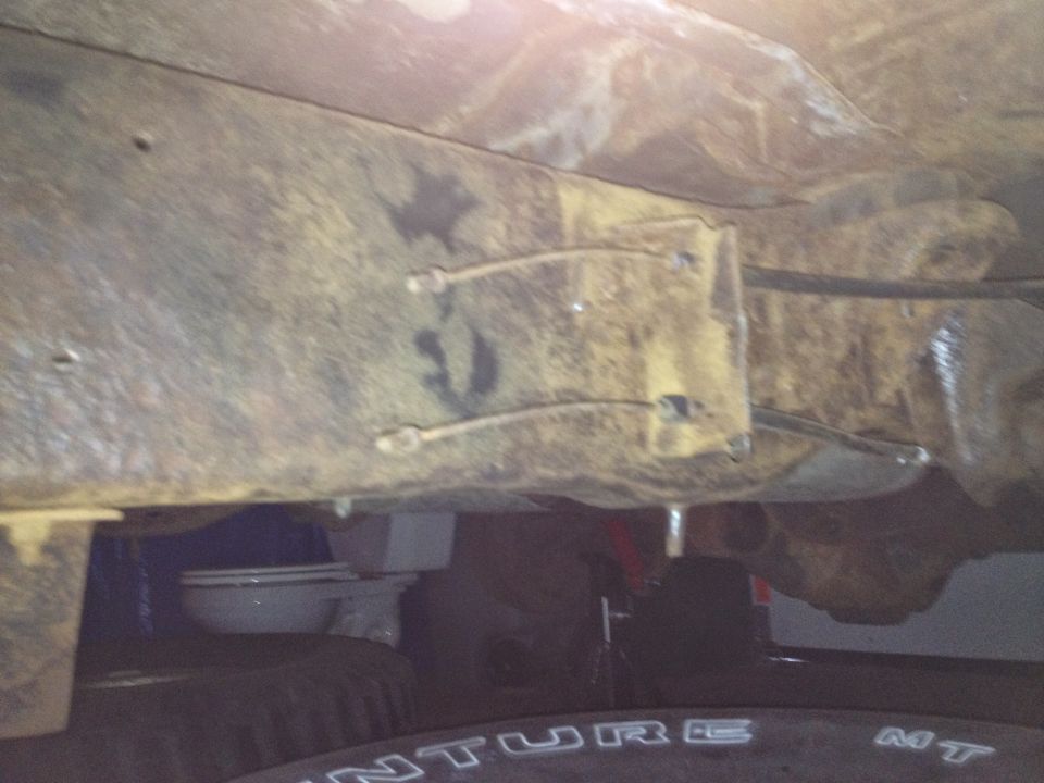 Photo of vehicle frame and brake lines from underneath the chassis