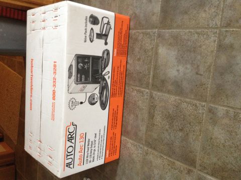 Photo of an Auto Arc 130 wire-feed welder box on a tile floor