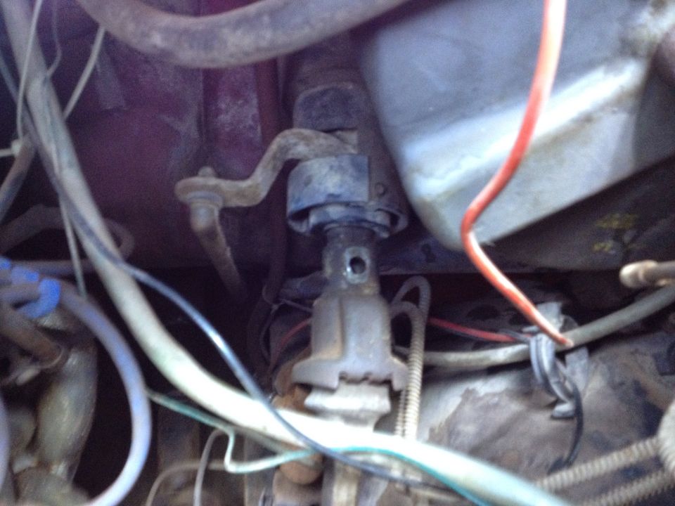 Close-up of vehicle steering column linkage with wires and hoses