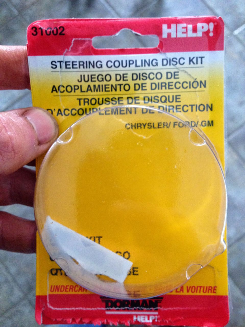 Help! Steering Coupling Disc Kit packaging with text in English, Spanish, and French, showing a yellow disc