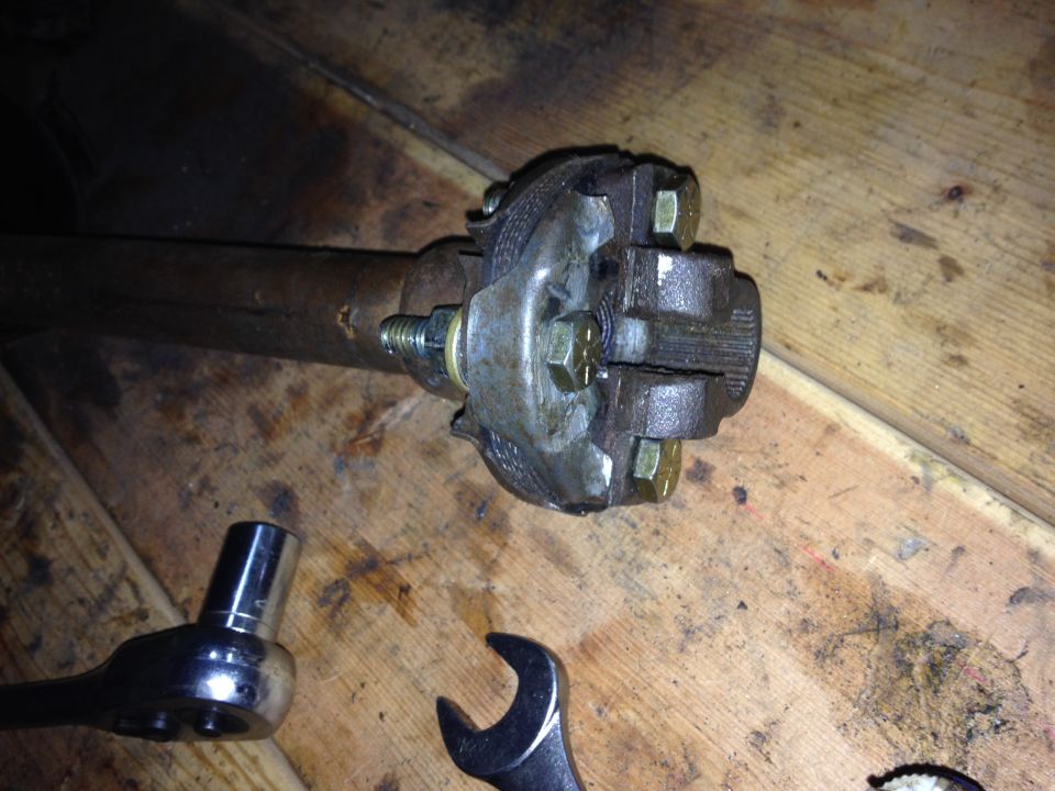 Photo of a U-joint or yoke on a shaft with wrench on a workbench