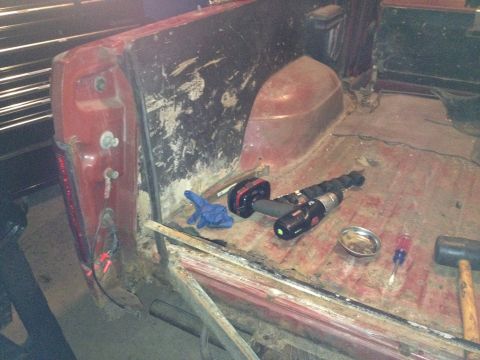 Photo of a vehicle cab interior with a drill and tools on the floor