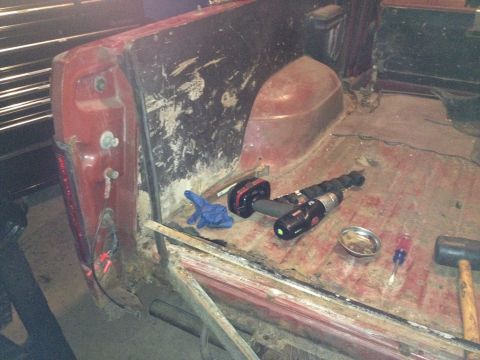 Photo of a vehicle cab interior with a drill and tools on the floor
