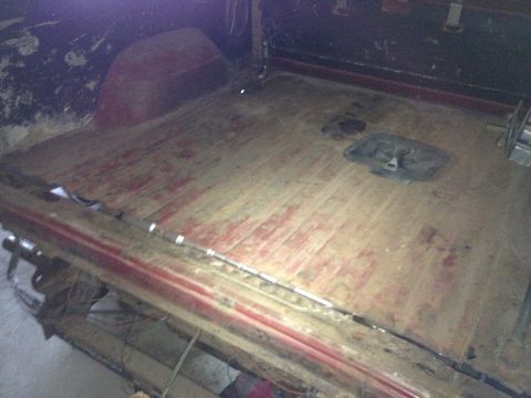 Photo of a bare wooden truck bed floor in a cargo box