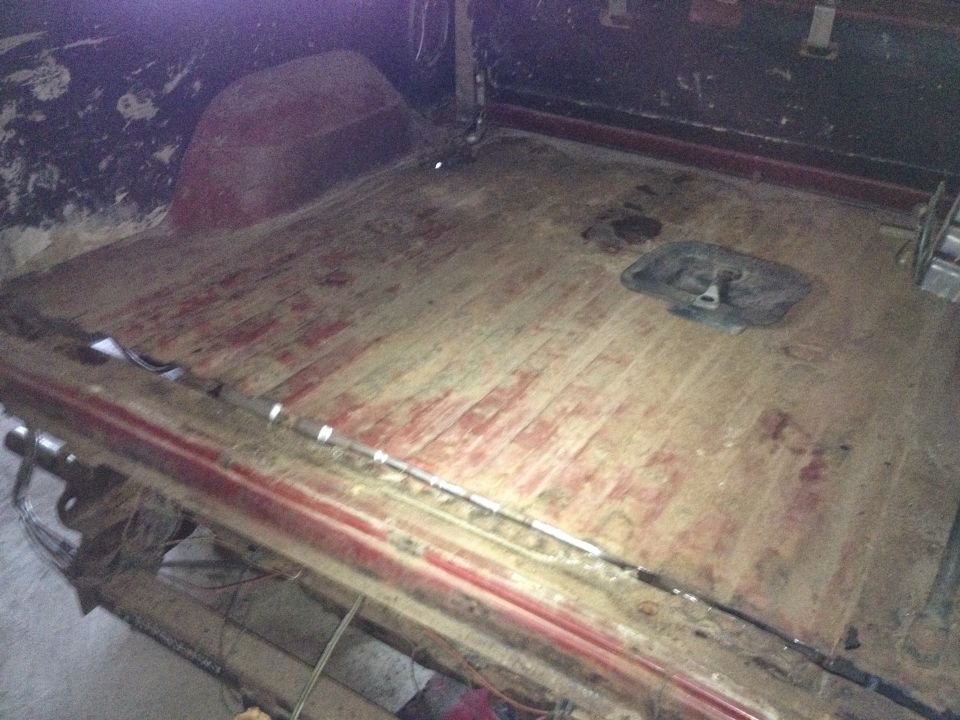 Photo of a bare wooden truck bed floor in a cargo box