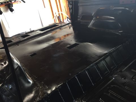 Photo of a freshly coated black vehicle bed and floor