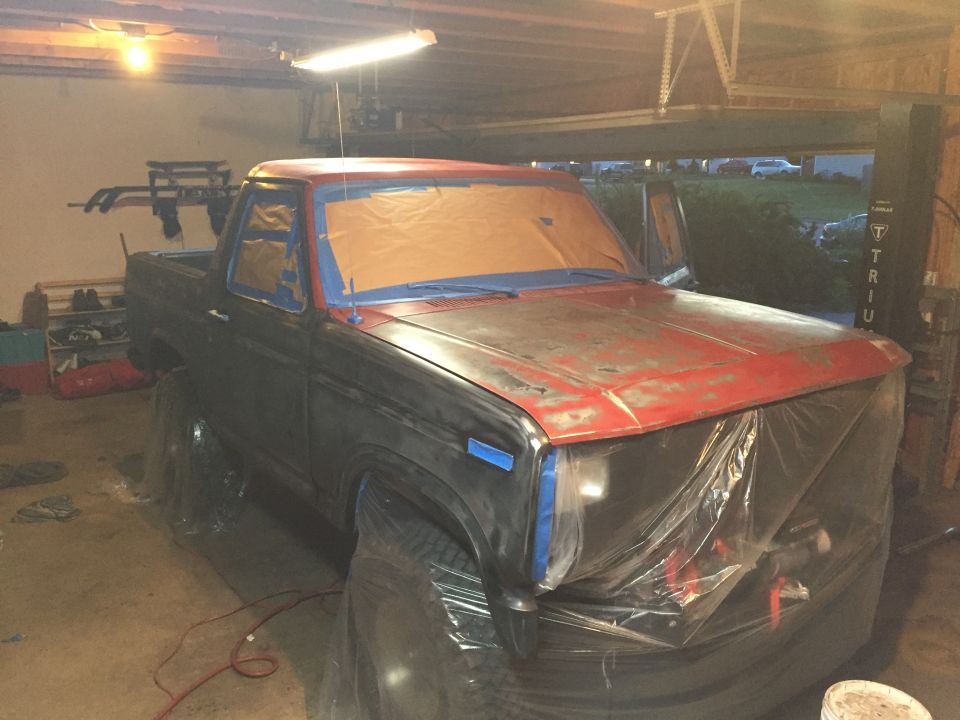 Project Bronco truck masked and primed in a home garage