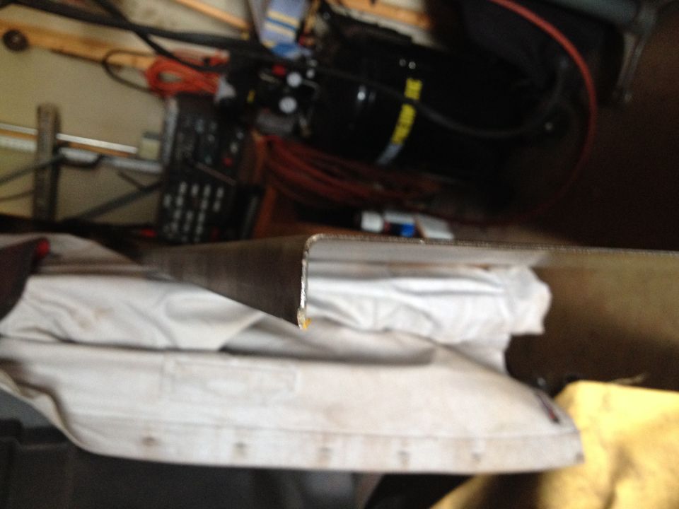 Close-up of a metal panel edge during fabrication in a garage