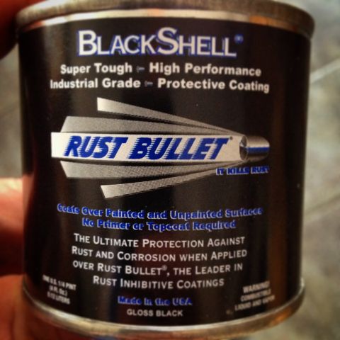 Hand holding a Rust Bullet BlackShell coating can