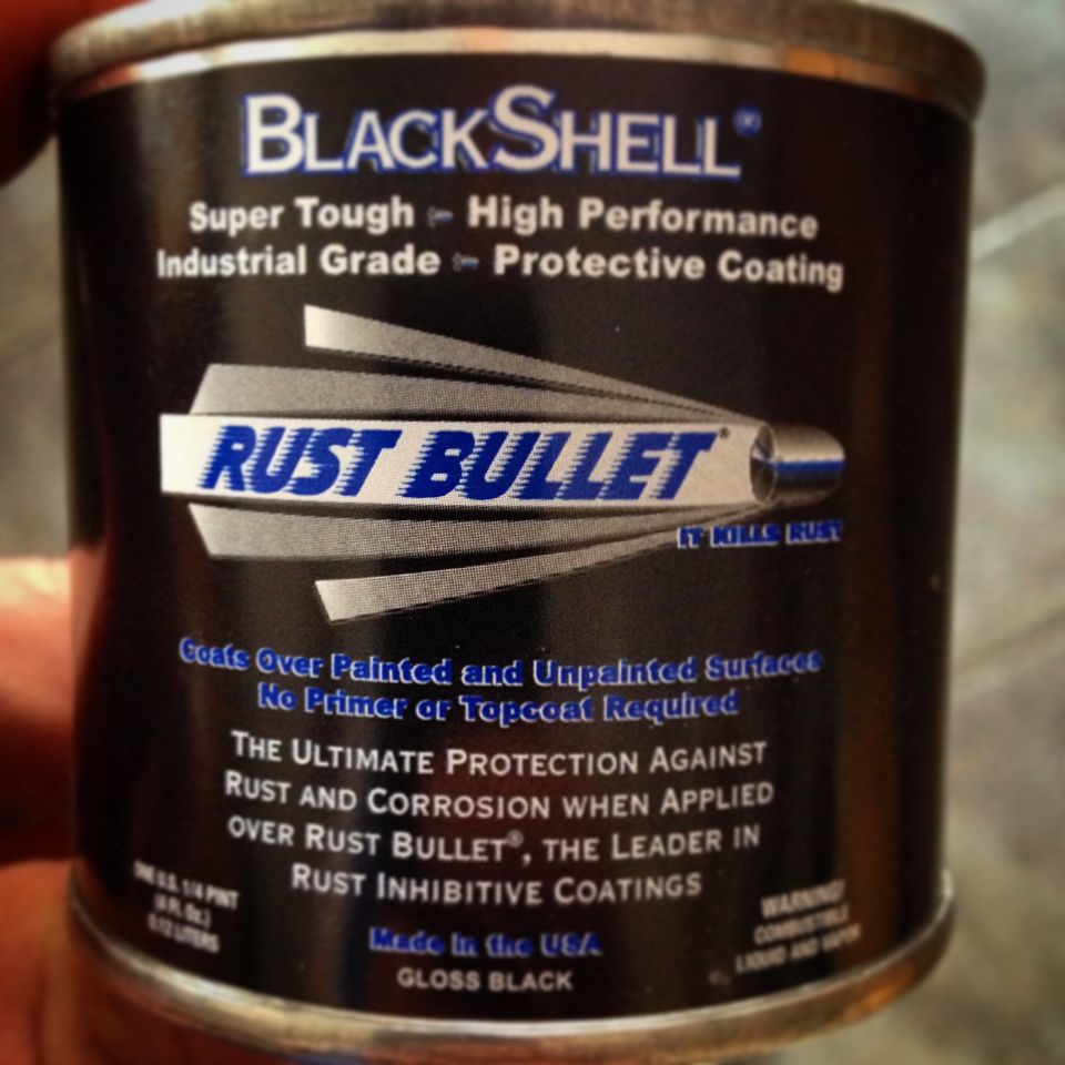 Hand holding a Rust Bullet BlackShell coating can