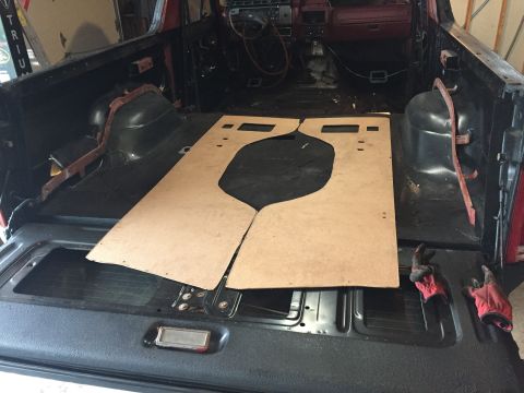 Cardboard floor templates laid inside a stripped truck cab