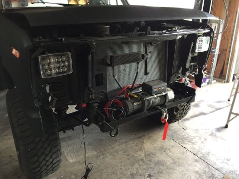 Truck front with LED headlights and winch mounted behind bumper
