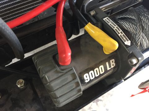 Close-up of a 9000 lb winch motor with red and yellow leads