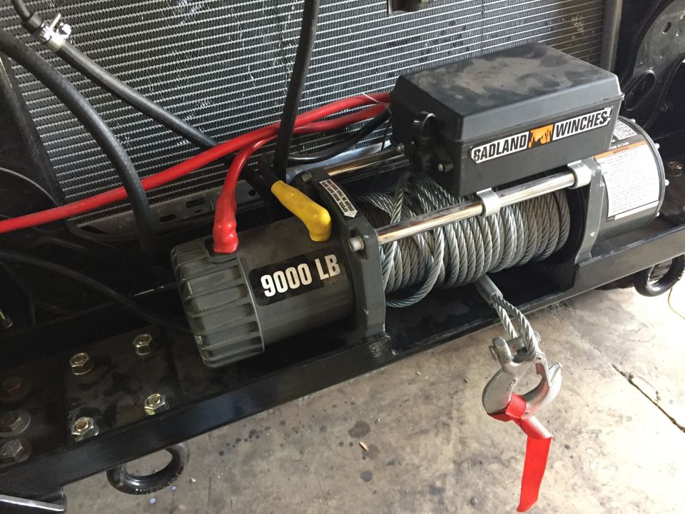 Badland 9000 lb winch mounted on a truck front frame