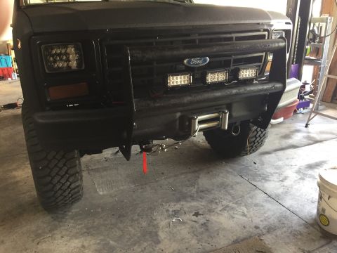 Black Ford truck front bumper with grille guard, winch, and LED bars