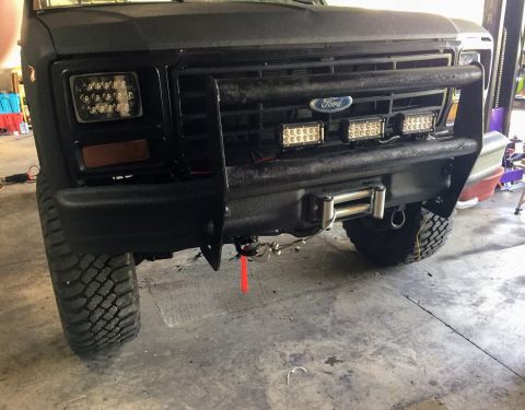 Black Ford truck grille and front bumper with winch and LED lights