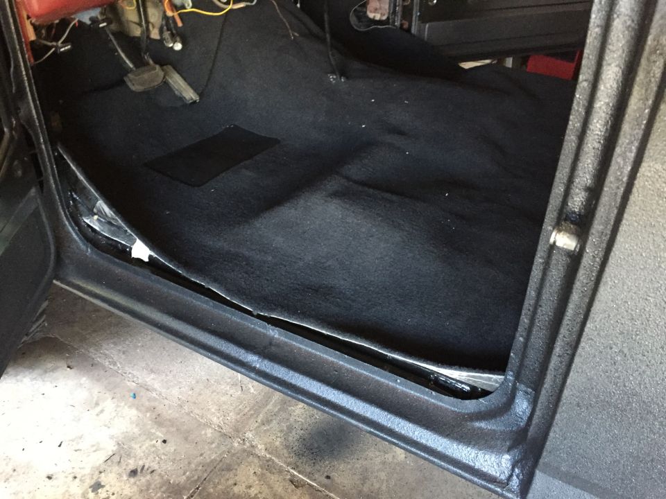 Black carpet and door sill of a Ford truck interior
