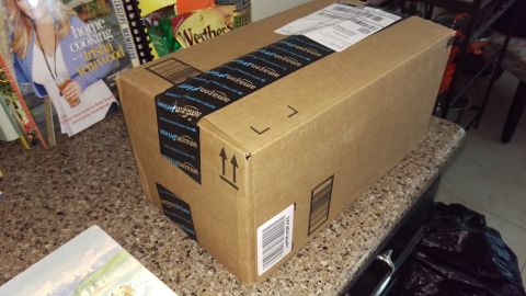 1994 Ford Bronco - Photograph of an Amazon cardboard shipping box on a counter, not a technical document.