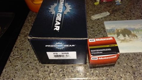 1994 Ford Bronco - Photograph of Premier Gear and Motorcraft product packaging boxes, not a technical document.